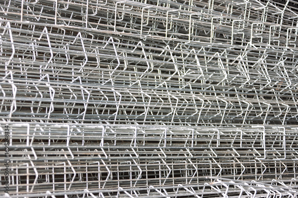 Obraz premium galvanized wire mesh pile, steel reinforcement field fence, abstract texture close up macro
