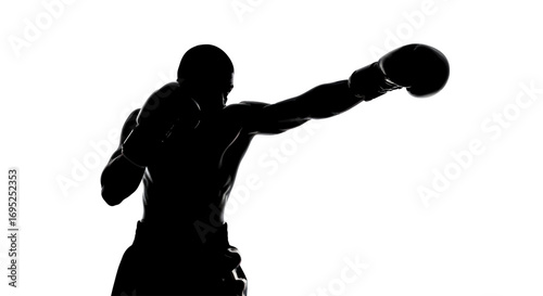 Silhouette of a determined boxer executing a powerful punch against a stark white background