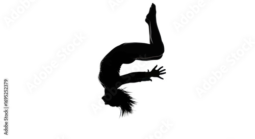 Silhouette of a graceful gymnast captured mid-air executing a backward somersault with stunning