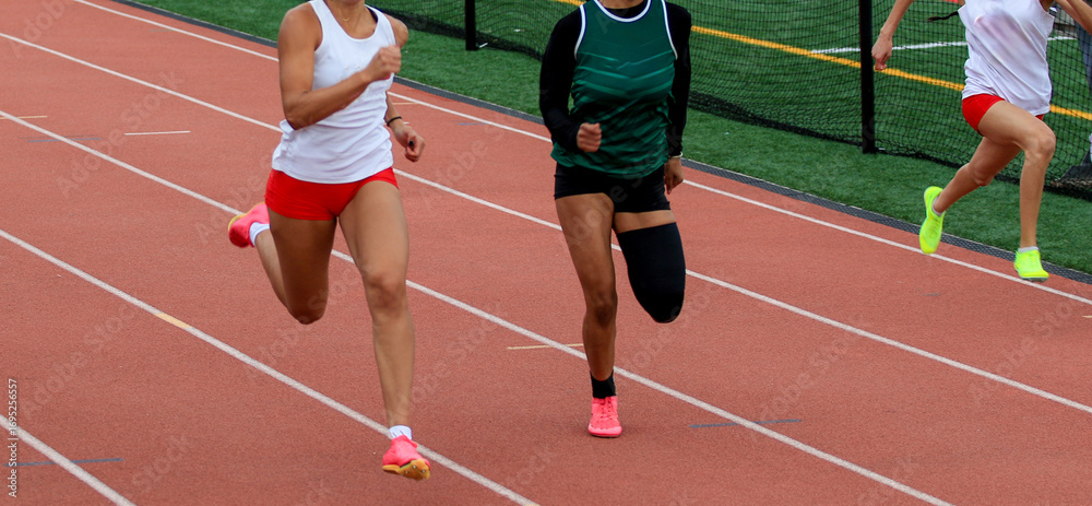 Fototapeta premium Runners Compete in Track Race at Local Athletic Meet During Sunny Day