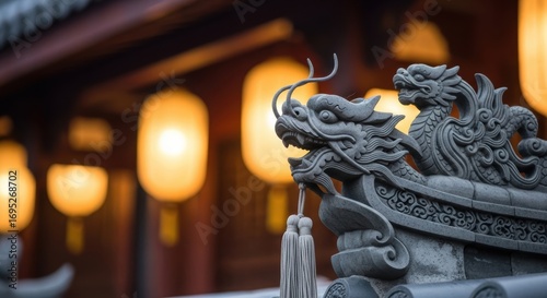 Decorative chinese stone dragons at temple with lanterns in background
