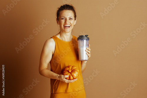 Autumn Nutrition: Woman with Shaker and Pumpkin