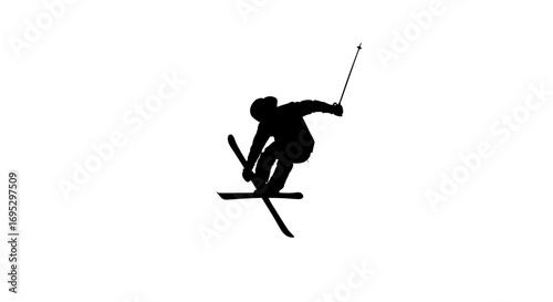 Dynamic silhouette of a freestyle skier performing a trick on a snow covered mountain slope