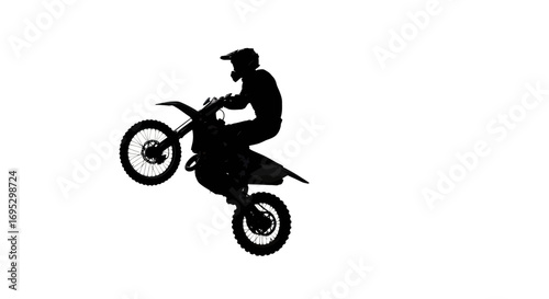 Silhouette of a motocross rider performing a wheelie against a white backdrop extreme sport