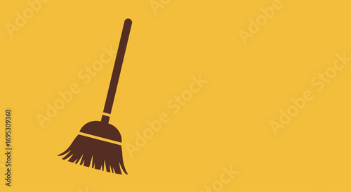 A stylized brown broom icon for cleaning and sweeping, isolated on a plain yellow background with copy space.