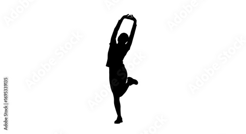 Silhouette of a woman performing a stretching exercise with one leg raised gracefully