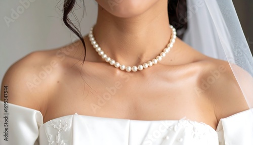 Close-up of bride's pearls and dress