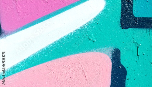 Vibrant graffiti art showcasing a dynamic interplay of pastel pinks, turquoise, and white colors on a textured wall.