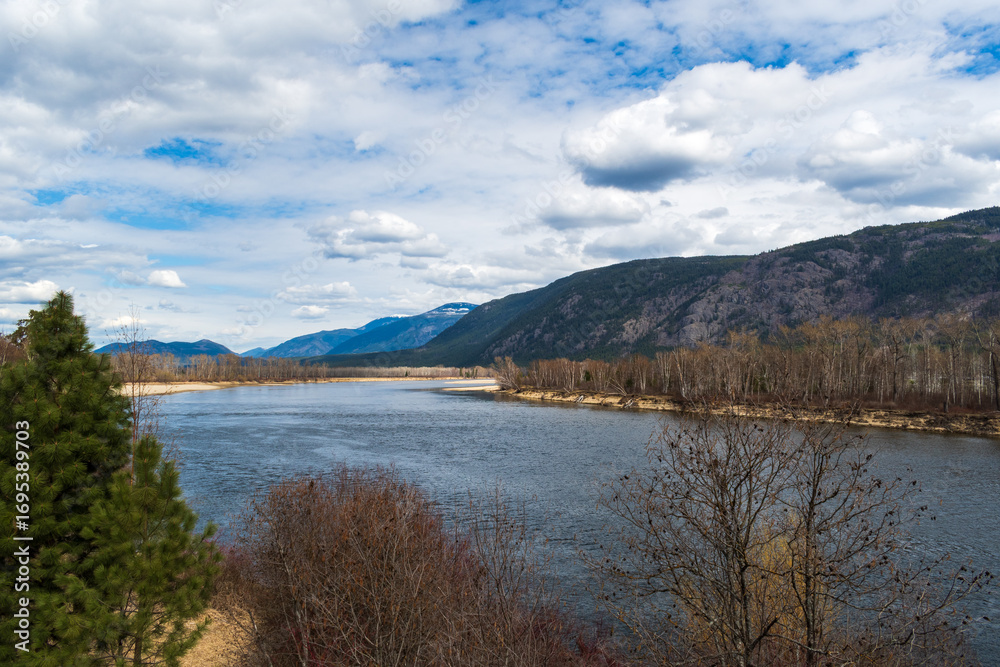Obraz premium Early Spring Landscape with River and Partly Blue Sky in Clearwater Valley, British Columbia