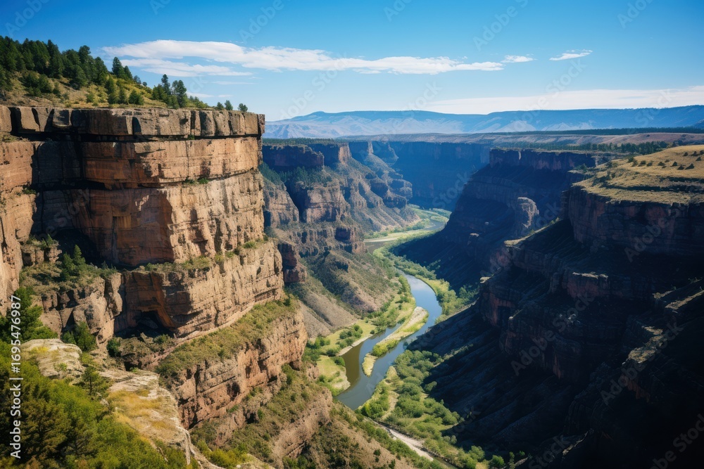 Fototapeta premium Towering sandstone cliffs embrace winding river valley canyon