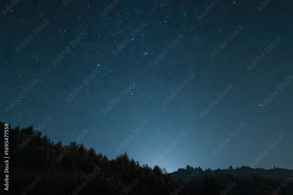Fototapeta premium Starry night over a dark hillside