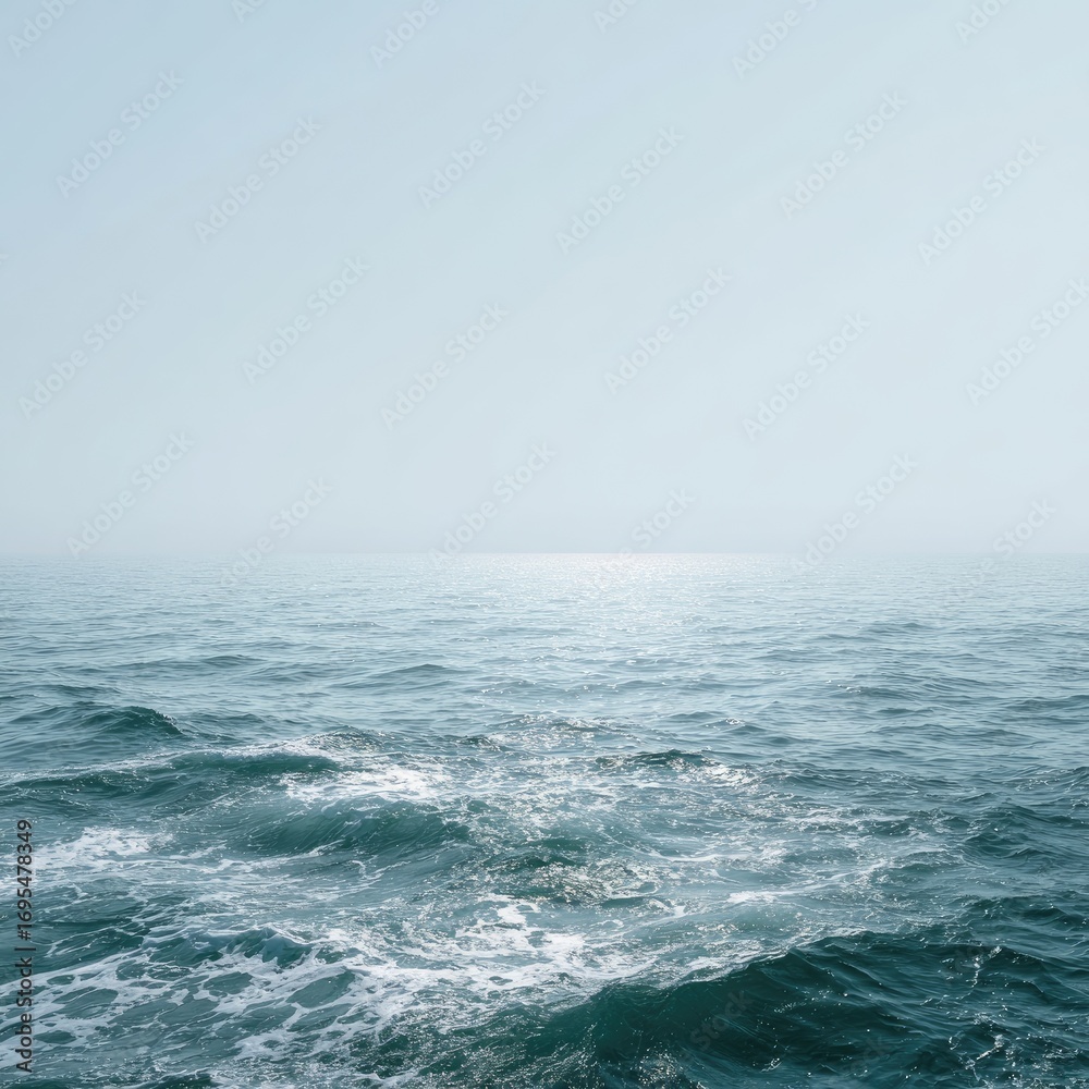 Fototapeta premium Vast, serene ocean, pale sky