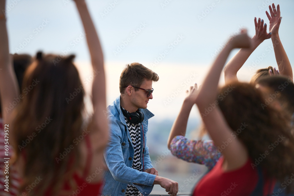 Φωτογραφία Caucasian young adult man wearing headphones standing among group of dancing you