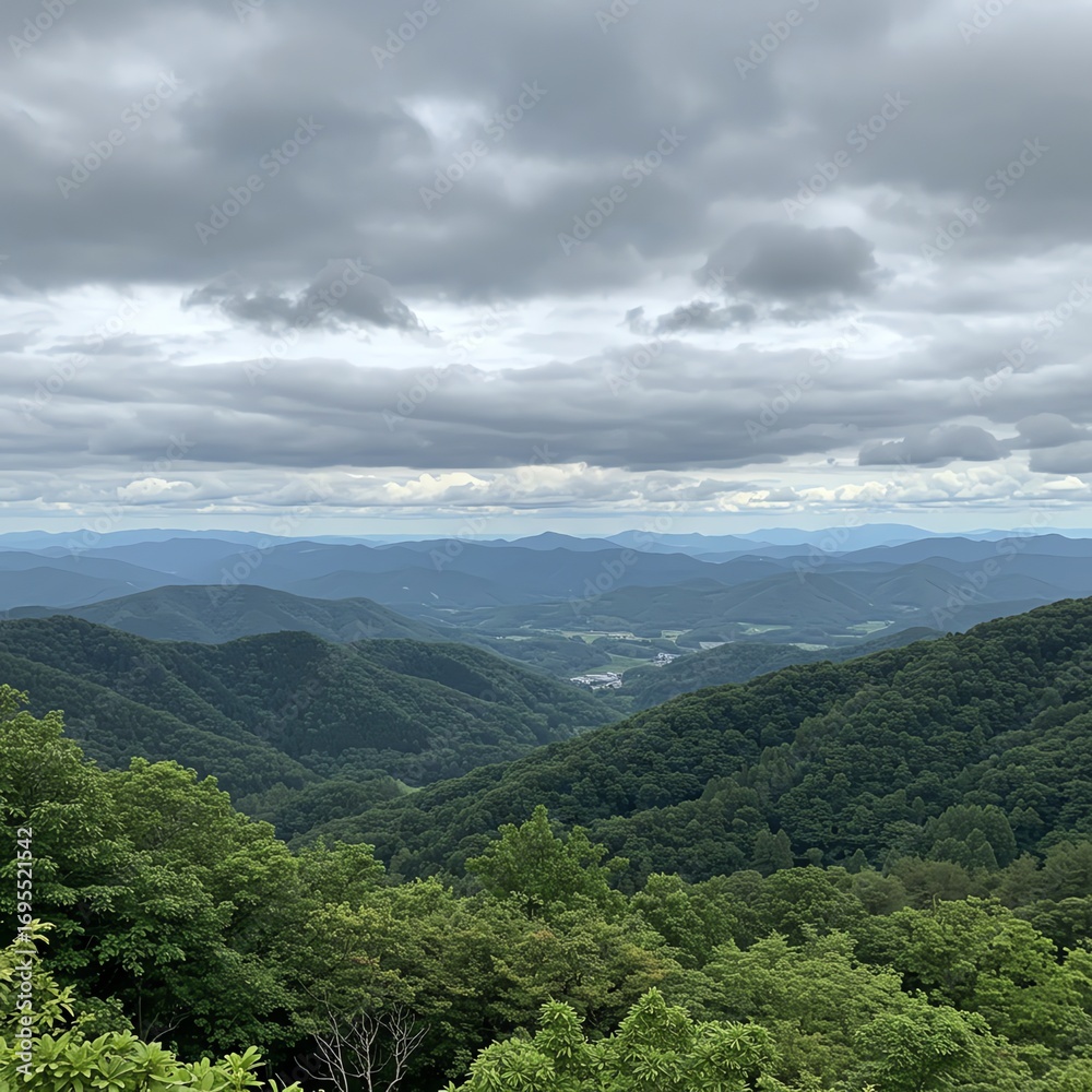 Naklejka premium Mountain range landscape with cloudy sky