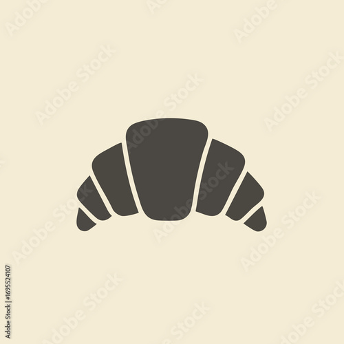 A simple, dark grey silhouette icon of a classic French croissant pastry on a plain, light-colored background.
