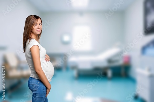 Free Download Beautiful pregnant happy woman hugging her tummy - GFXLoad