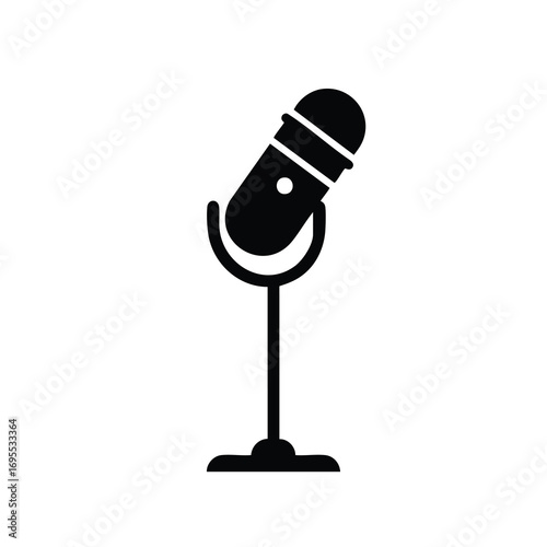 A simple black and white illustration of a vintage microphone on a stand, representing audio recording and broadcasting.