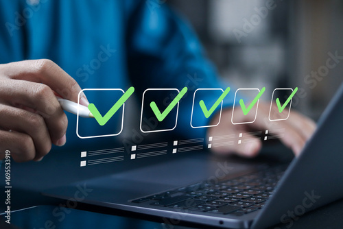 Digital checklist concept, Survey form, online quality assessment, and filling out digital form checklist. Businessman makes mark on the survey topic.