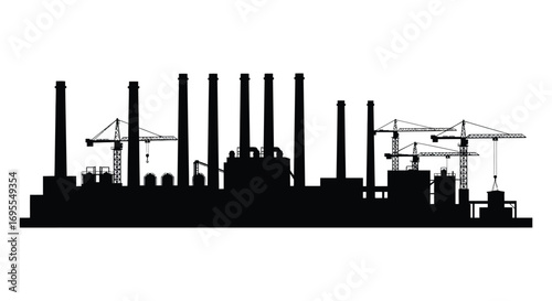 industrial skyline with tall chimneys and construction cranes