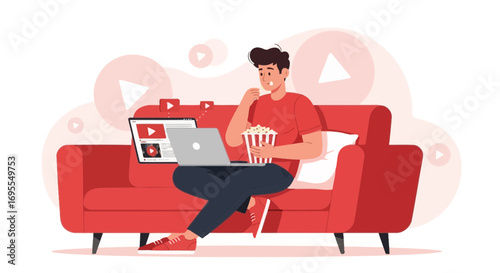Young Man Relaxing On Couch Watching Videos Online and Enjoying Popcorn