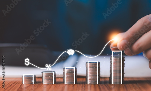 Hand arranging a glowing line graph over coin stacks, symbolizing financial growth, investment success, and smart savings strategies for future wealth management.