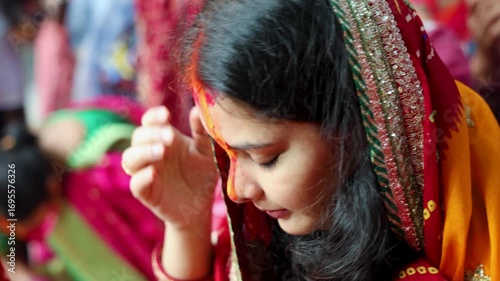 sacred sindoor offering ritual by devotee at chhath puja celebration