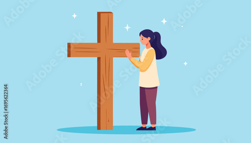 A quiet moment of faith for a young woman as she prays devoutly before a large wooden Christian cross