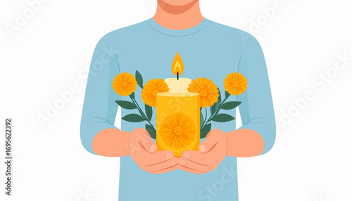 Person's hands holding a memorial candle decorated with marigold flowers. A solemn offering for remembrance and tradition