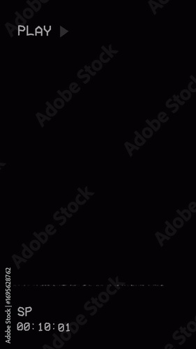Vintage VHS animation plays from analog television against a dark background, with PLAY sign, time code display, static lines, and distortion. 4K vertical video.