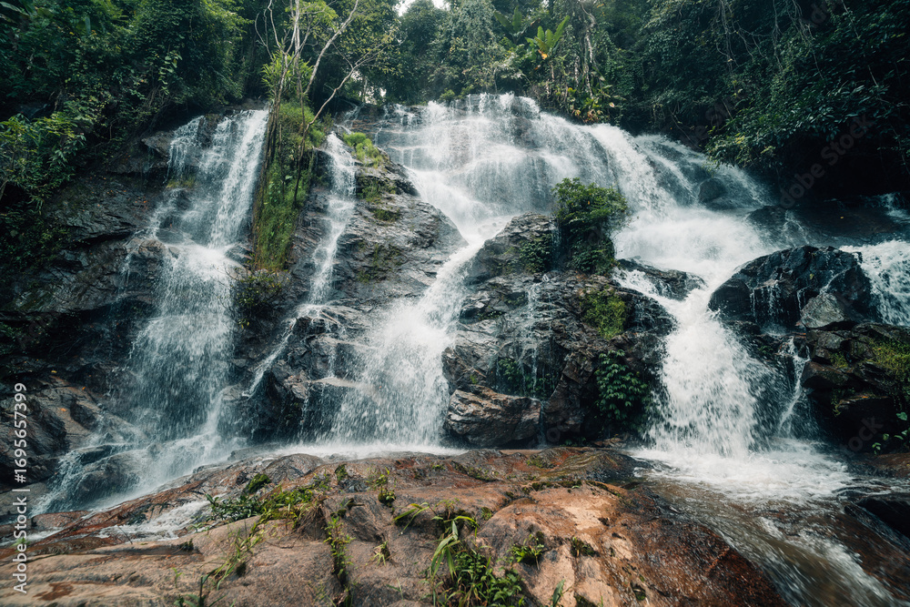 Obraz premium Waterfall landscape in natural forest, watershed and environment in tropical forest of Thailand