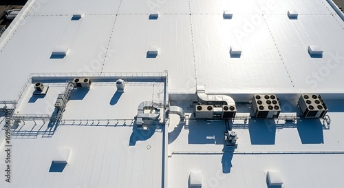 Expansive white commercial rooftop showcases HVAC units and ventilation systems under bright sunlight