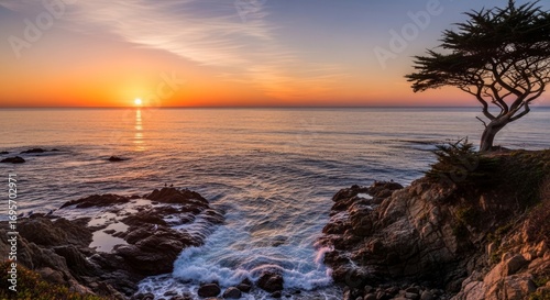Sunset over the ocean with waves crashing against rocks and a lone tree on a cliff