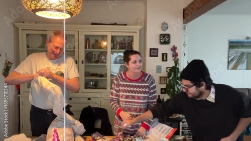 Latin American Traditions for Christmas and New Year in Europe Family is gathering around a wooden table, preparing an año viejo effigy, a Latin American Ecuadorian tradition for New Year's Eve