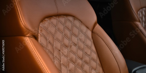 A detailed shot of a luxurious brown leather car seat with diamond stitching, showcasing automotive elegance.