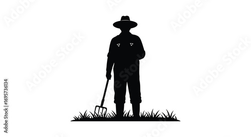 a farmer silhouette holding a pitchfork standing in grass