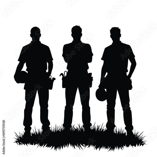 Three construction workers holding hard hats standing on grass