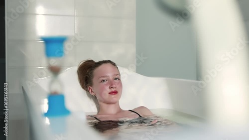 A girl takes a therapeutic thermal bath.