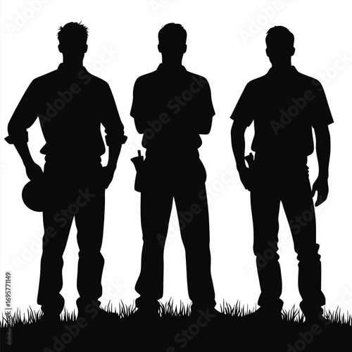 Three male construction workers silhouettes standing on grass