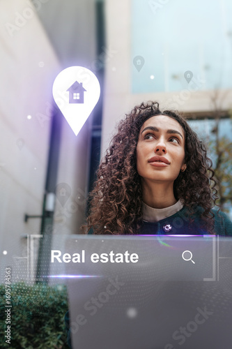 Real estate professional exploring property options while using a laptop outdoors in an urban setting