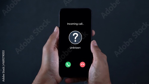 Holding smartphone displaying incoming anonymous call with question mark symbol and accept or reject options, representing mystery and potential danger
