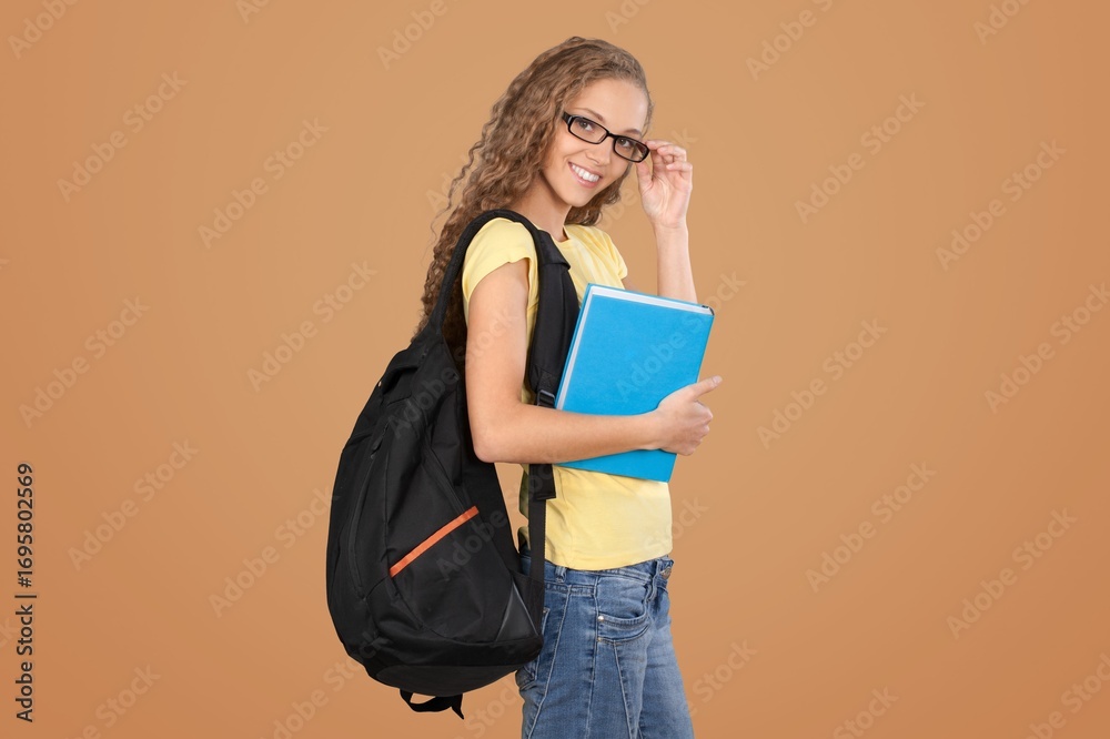 Fototapeta premium Young student holding books ready for study