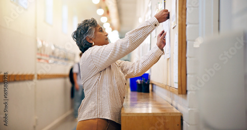 Φωτογραφία Bulletin board, announcement and woman in school hallway, motivation and sign up for program