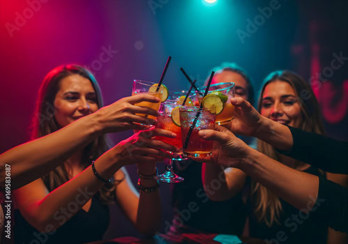 Ladies celebrating with colorful drinks in a vibrant bar setting.