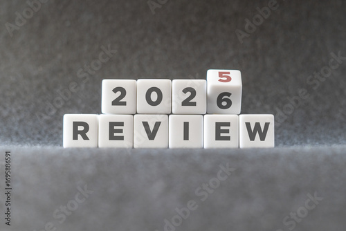 Flipping of 2025 to 2026 on white blocks. 2025 business and customer review for business strategic planning in the next year 2026. End of the year business concept