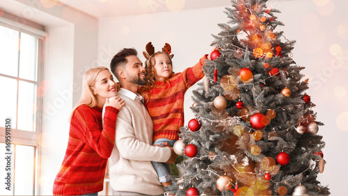 Young family decorating Chr...