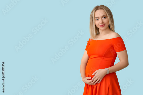 Happy pregnant woman on blu...
