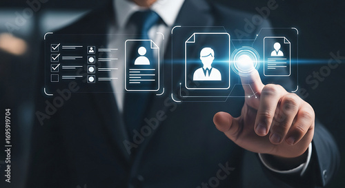 Business professional interacts with digital interface showcasing employee profiles and career development data on screen