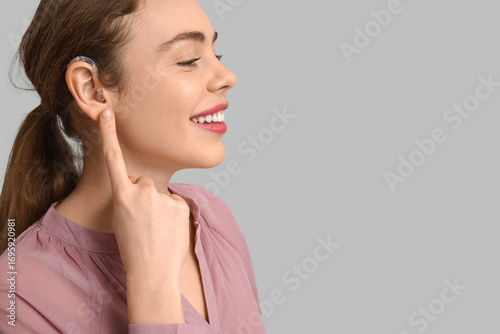 Happy young woman pointing ...