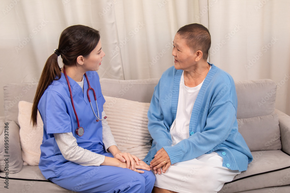 Fototapeta premium Young female nurse holding hands with senior woman, both smiling with trust and warmth during health support session in cozy home setting, healthcare, caregiver, take care, consult.
