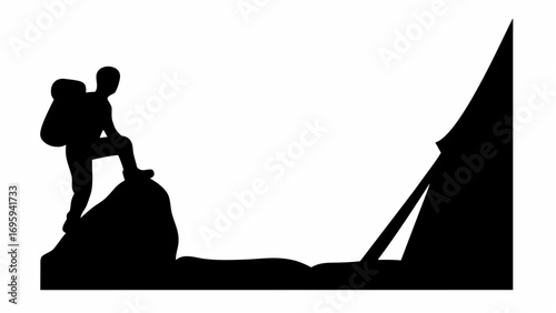 Silhouette of a hiker with backpack standing on a rock near a mountain peak in black and white style